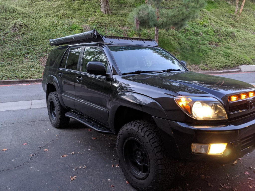 Front passenger side view of Toyota 4Runner with Step Edition bolt on rock sliders - Cali Raised LED