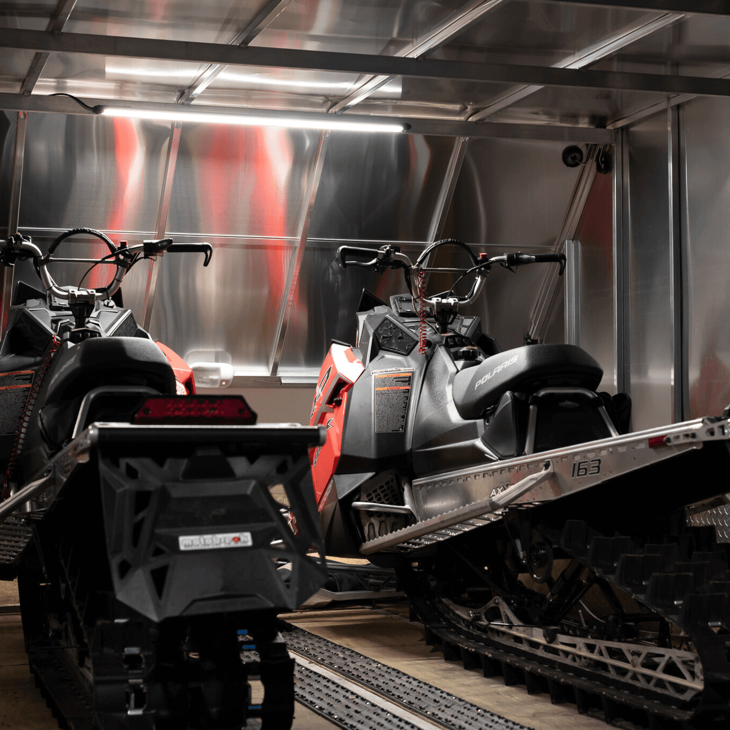 forty inch kingpin light in enclosed trailer with two snowmobiles