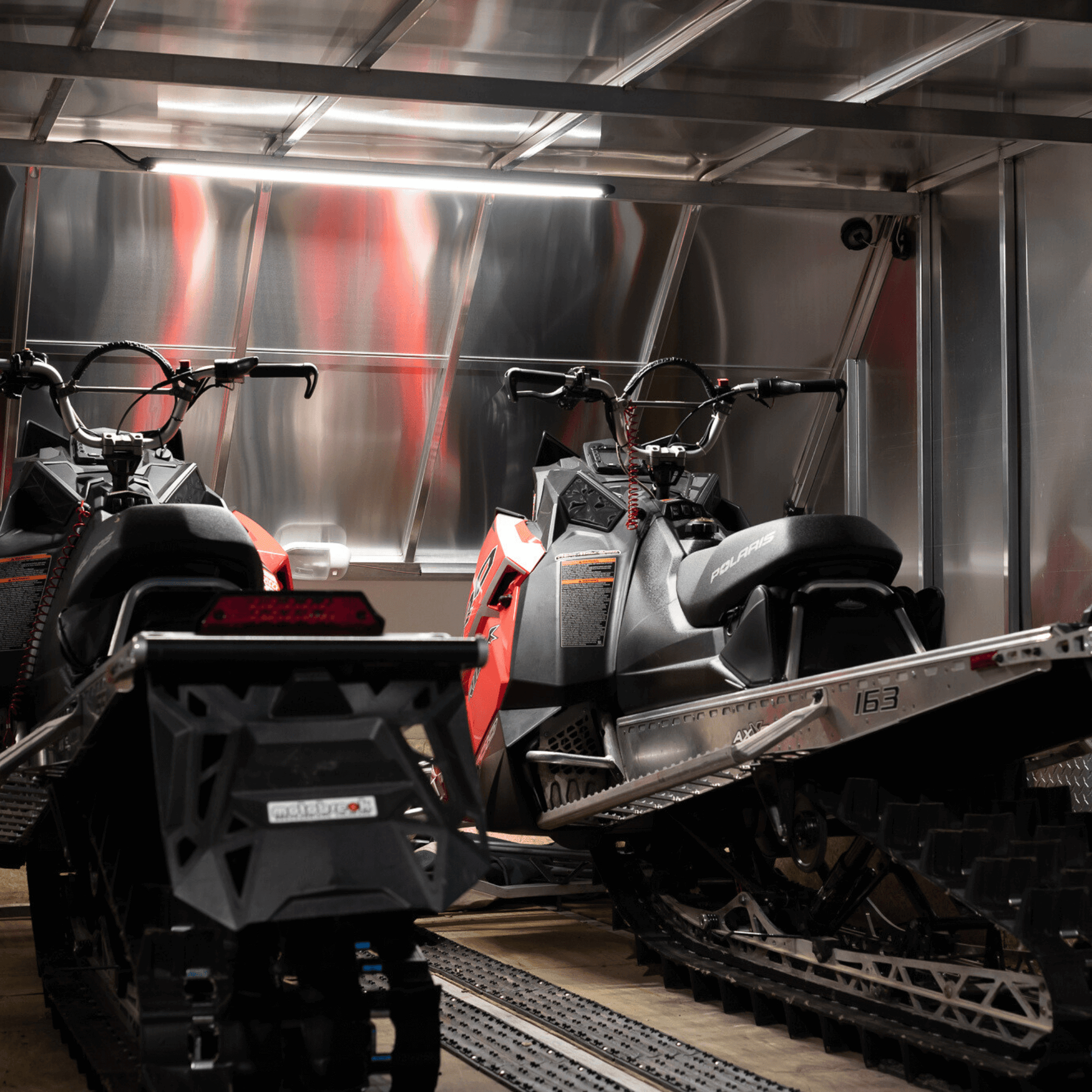 forty inch kingpin light in enclosed trailer with two snowmobiles